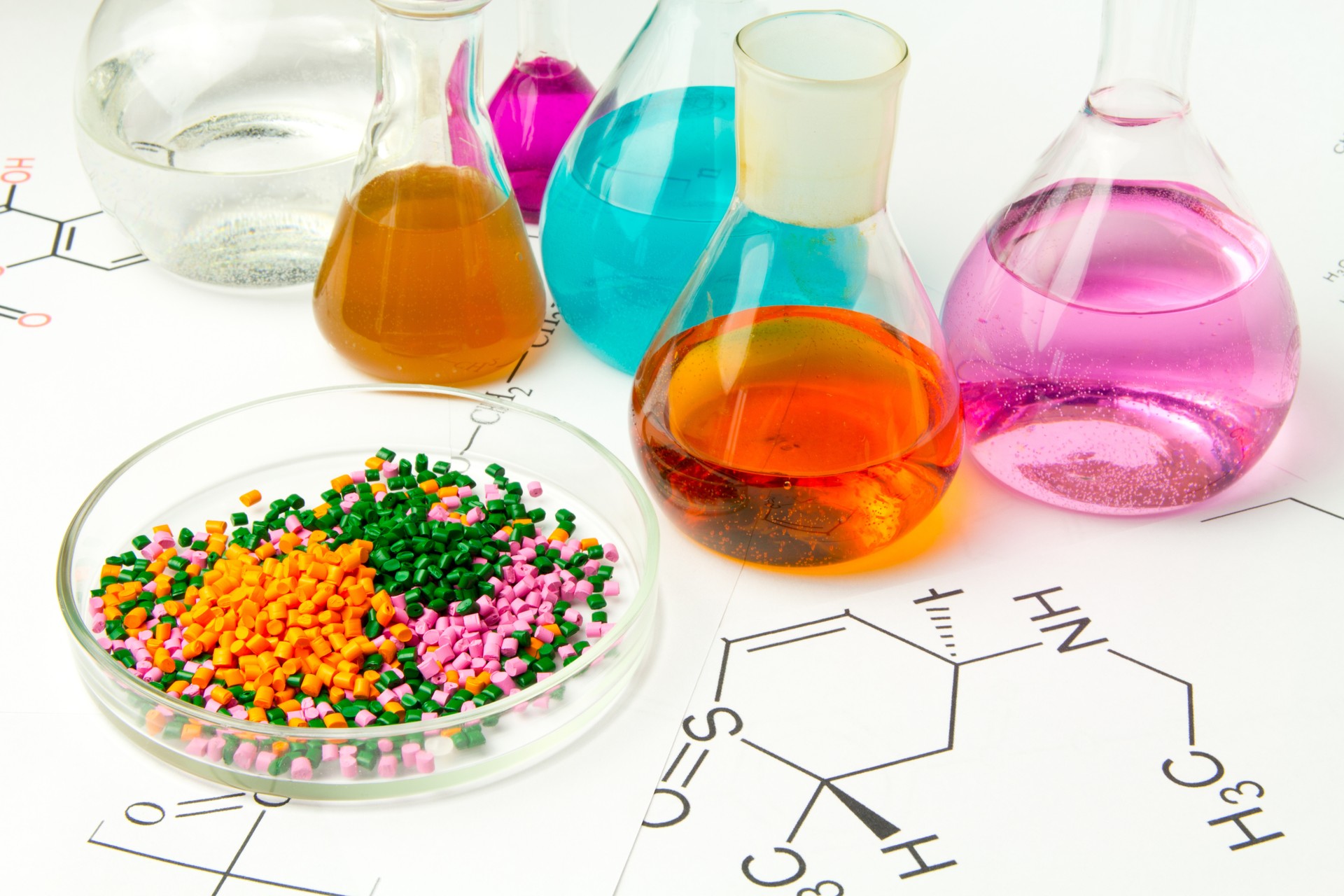 Plastic raw material in granules against the background of Chemical Laboratory and reagents. Polypropylene, Ethylene, Polypropylene research in laboratory conditions